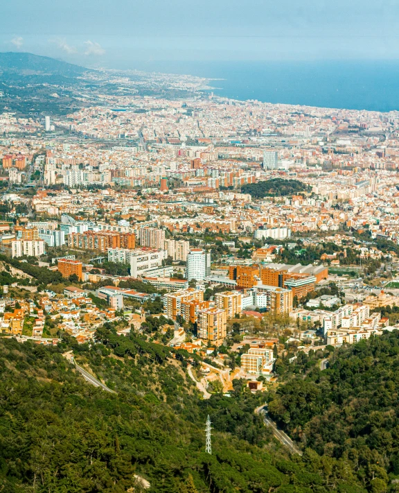 there is an aerial view of a city and mountains