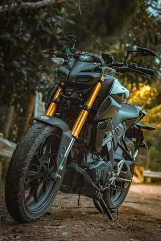 a motorcycle parked in the dirt on a road