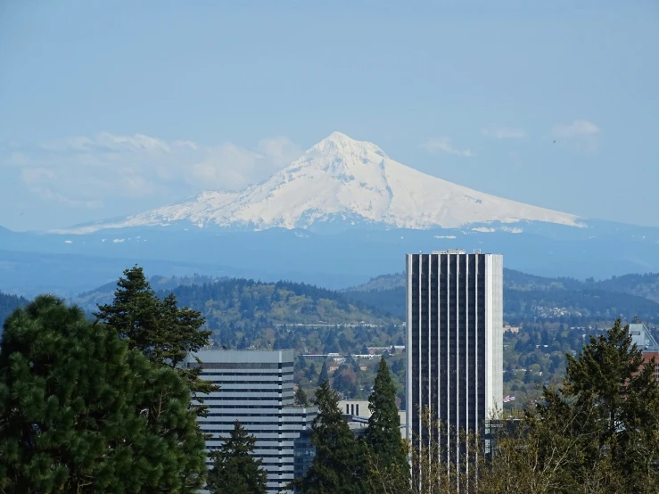 a big tall building in front of a mountain