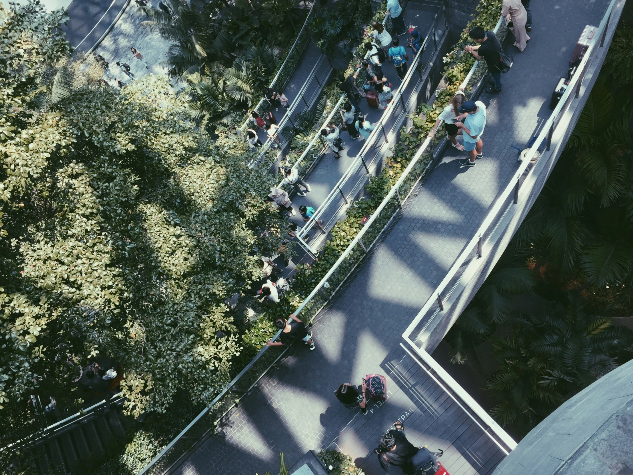 a view down the street looking up at people sitting in a bench