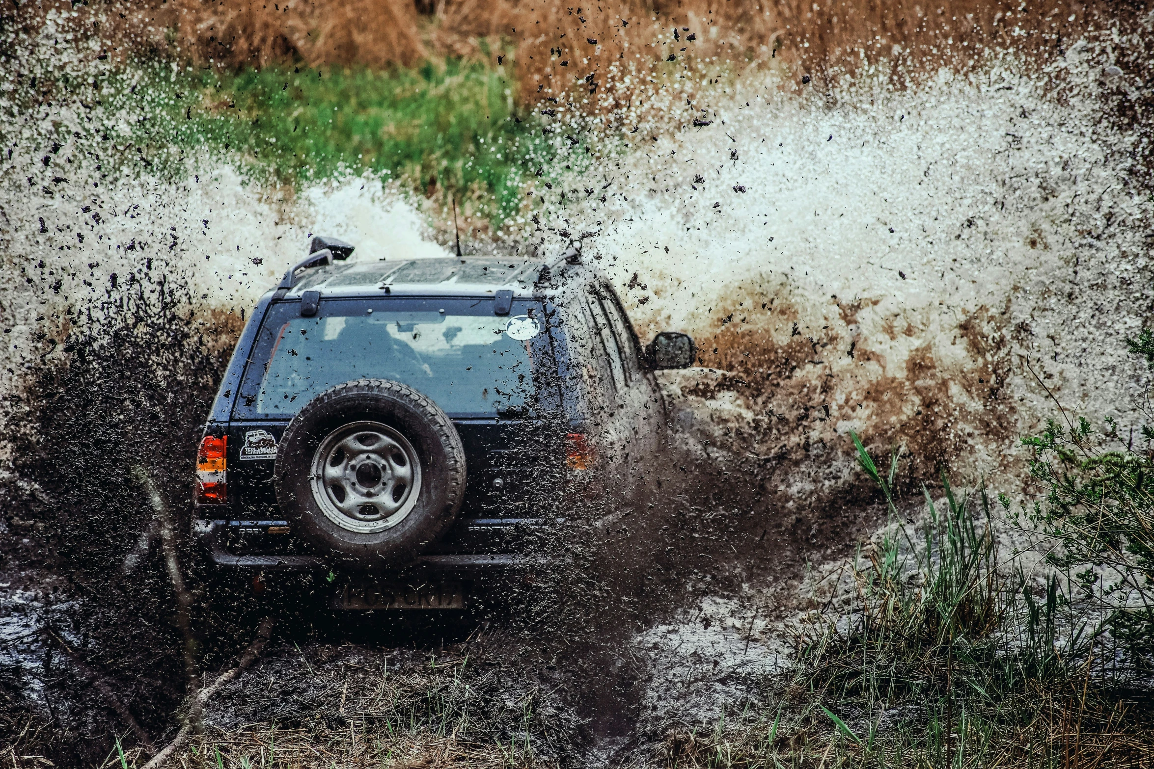 the car is driving in the mud