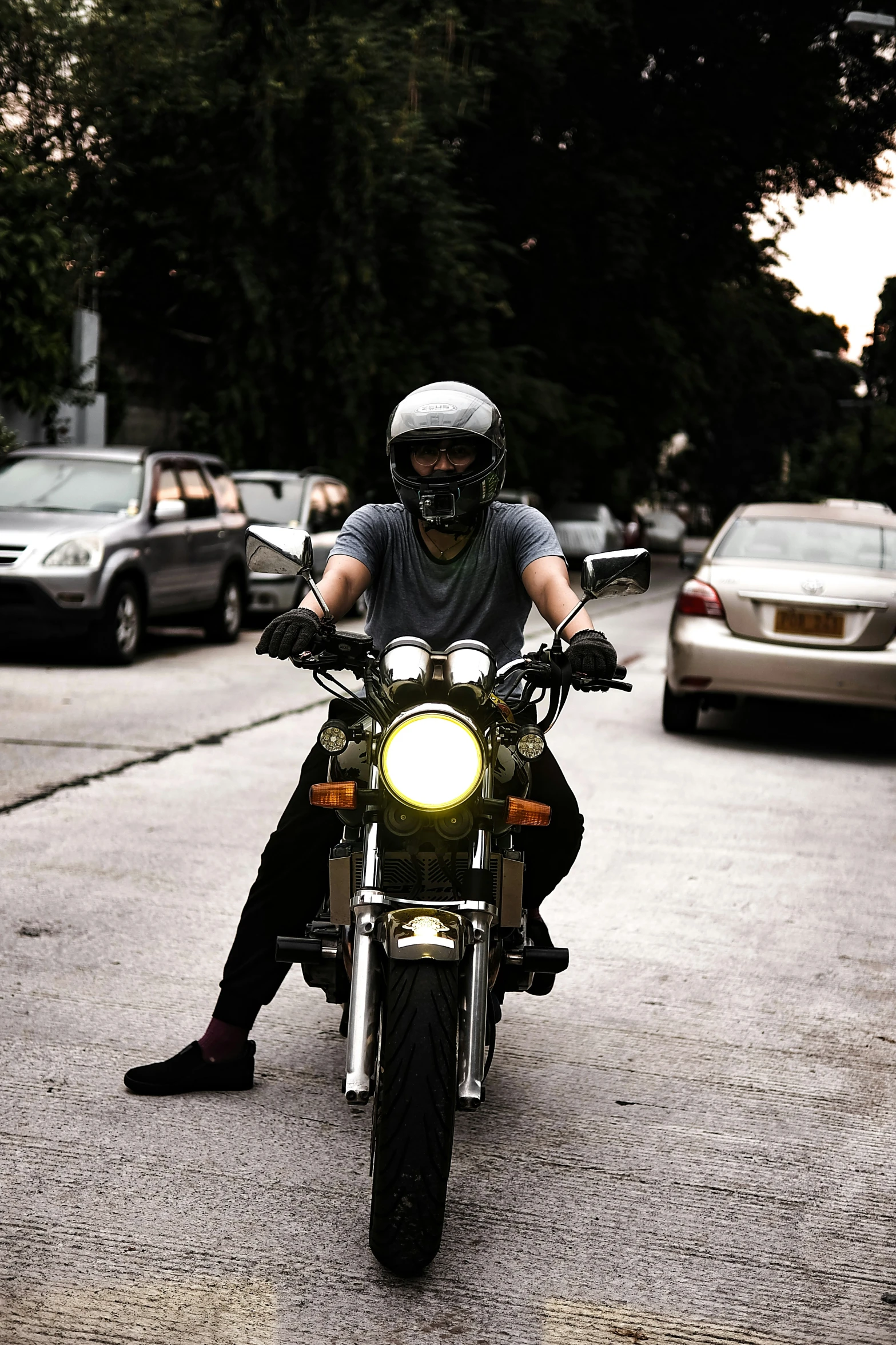 a man sitting on his motorcycle on a street