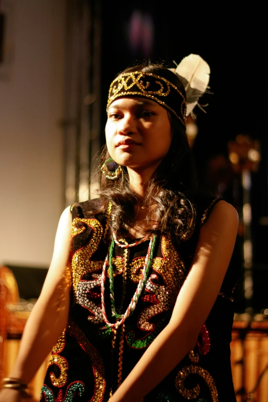 the beautiful woman with a black hat and necklace