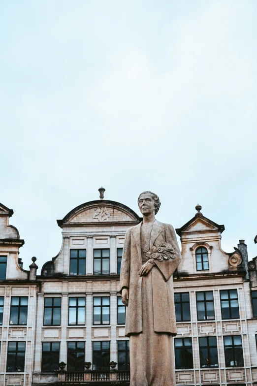 there is a statue that is next to a building