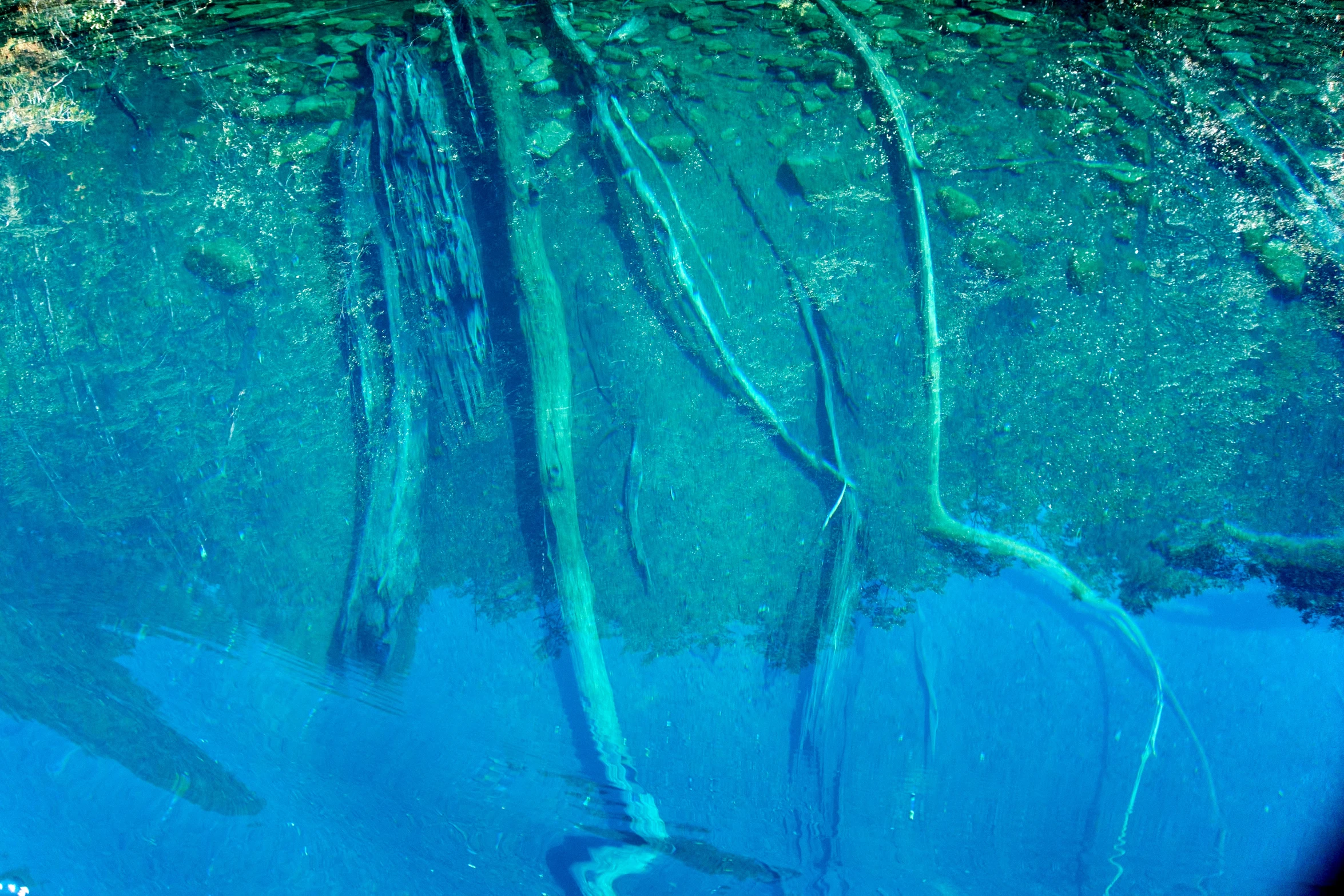 a reflection of a boat in the water