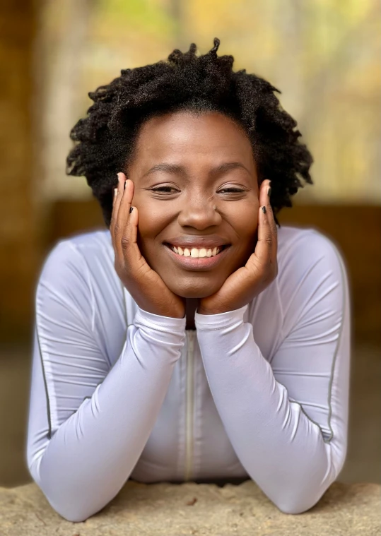 smiling woman with short natural hair posing for the camera