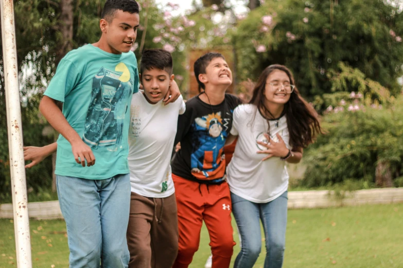 four friends posing for a po at a park