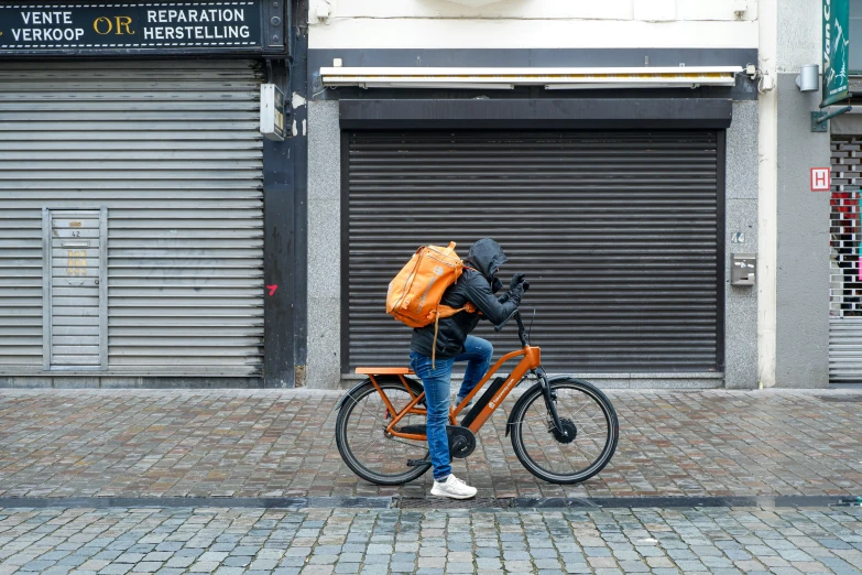 the person with a backpack is on a bicycle