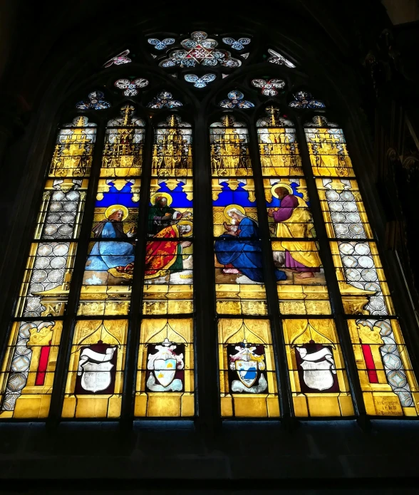 an old stained glass window with people and symbols