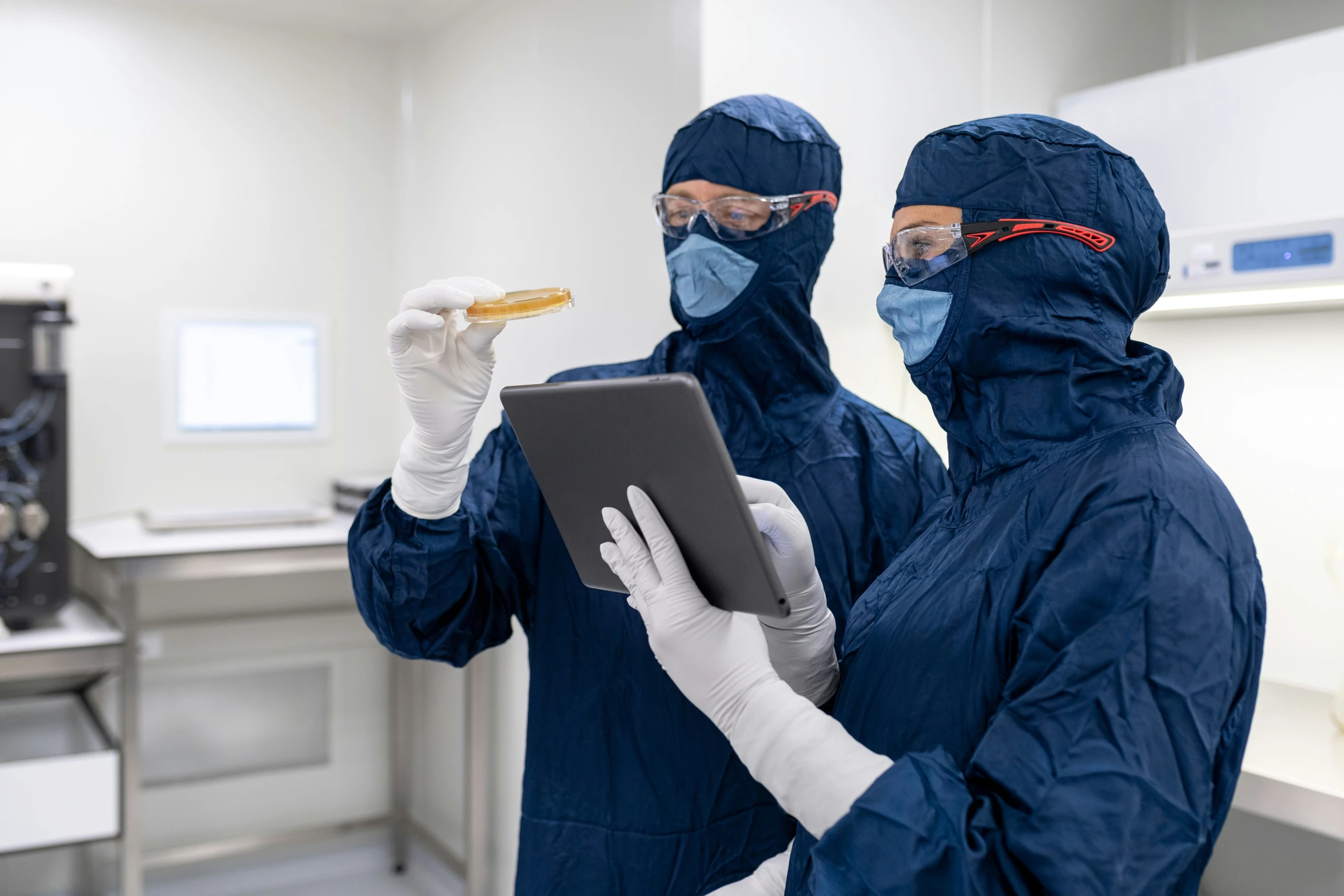 two people wearing masks holding food in front of them