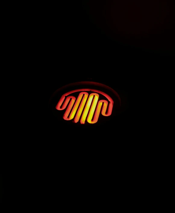 a po taken of an illuminated shop sign in the dark