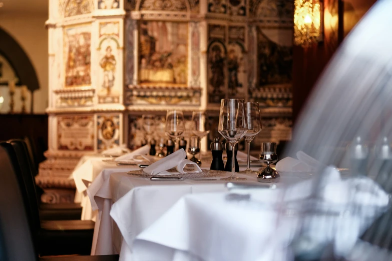 a table with two wine glasses, napkins and silverware on it