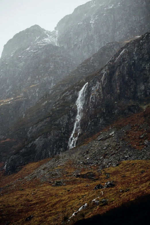 two steep hills and a waterfall in the rain