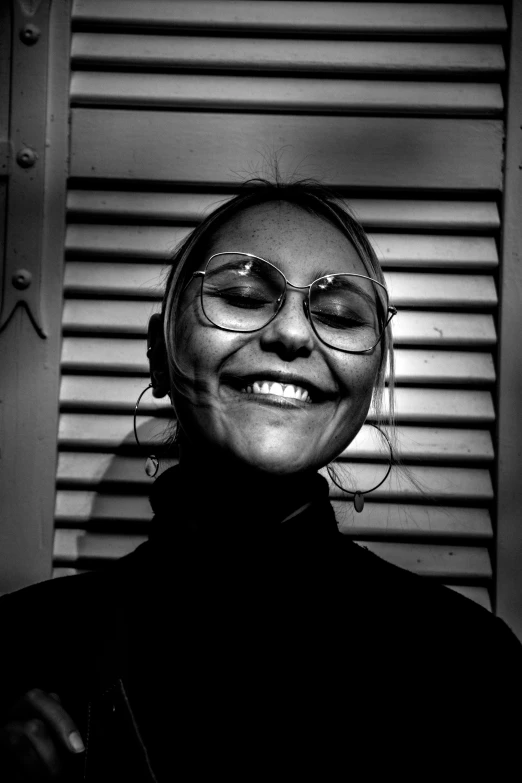 black and white po of a woman wearing glasses