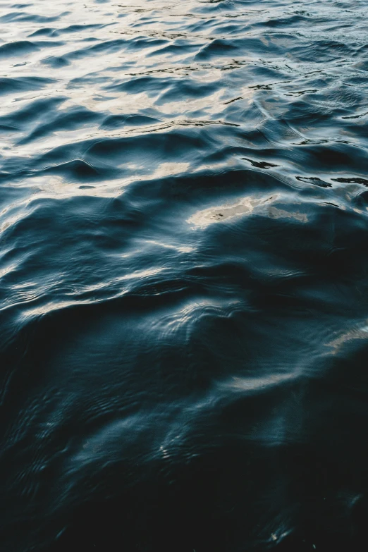 water with wavy waves and bubbles on the surface