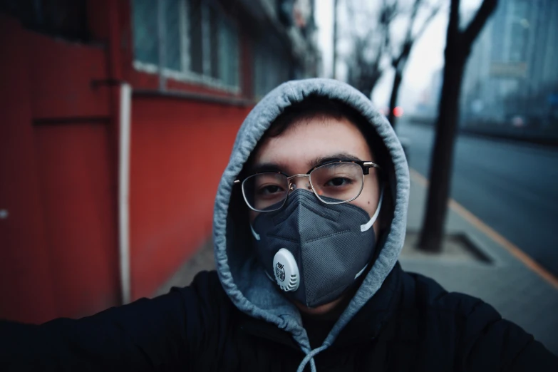 man wearing a mask and jacket is outside