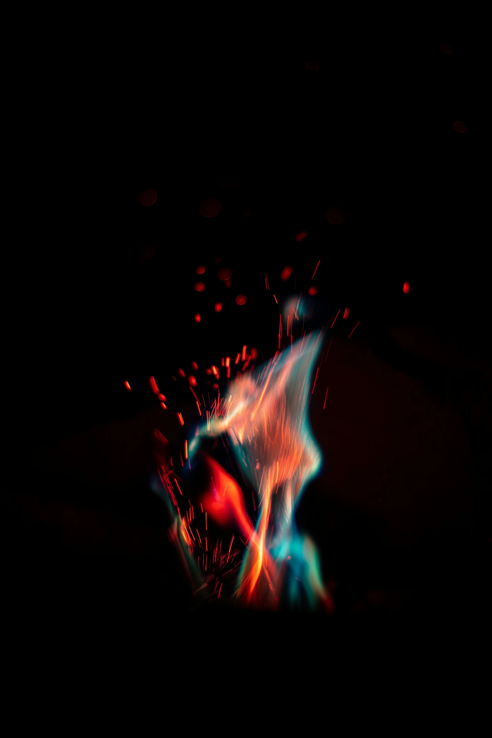 firework coming from fire and sparks, with red blue green and orange light