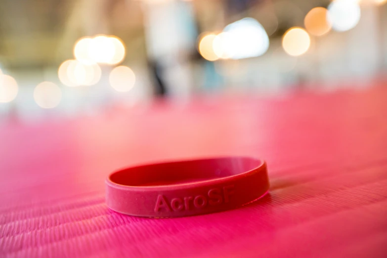 a celet sits on the floor on top of a pink surface