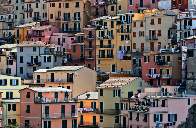 many multi - colored buildings stand together in a row