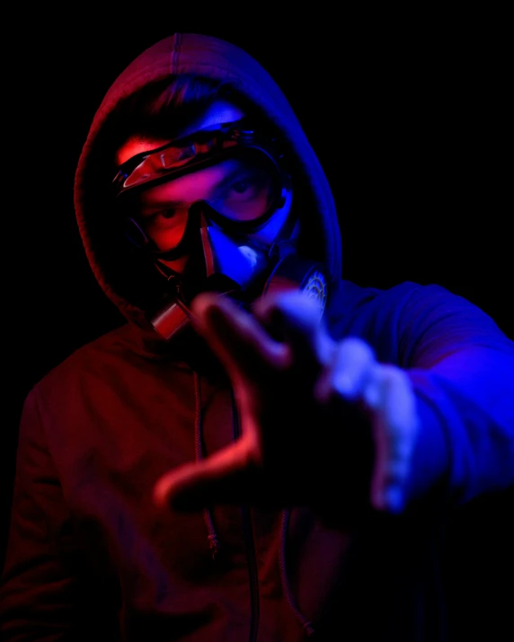 a man wearing a gas mask points at soing