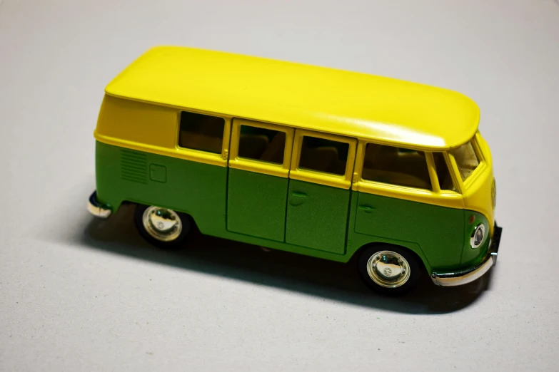 a green and yellow bus sitting on top of a table