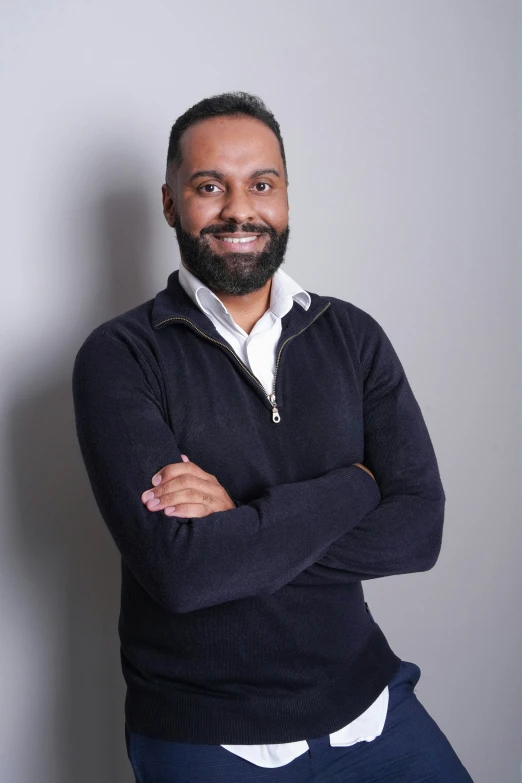 a man is posing for a po with his arms crossed