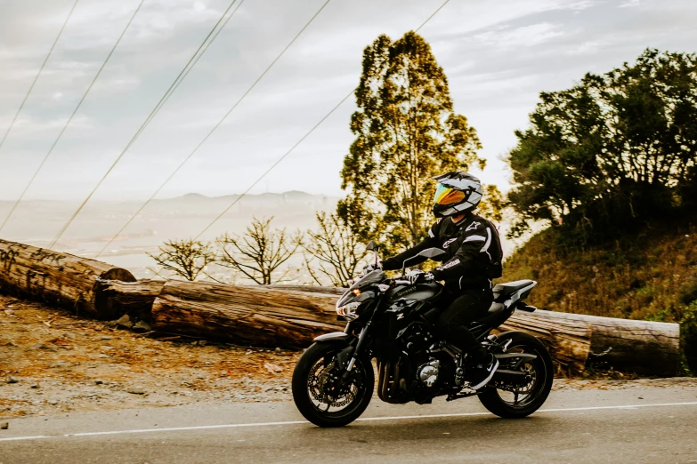 a person riding on the back of a motorcycle down a road