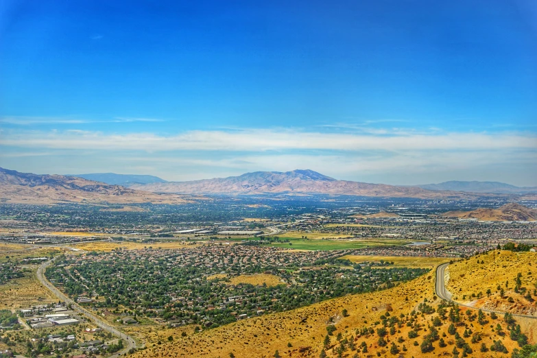 an aerial view of many mountains, trees and roads