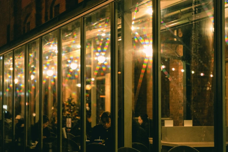 people are sitting in chairs at an outdoor cafe