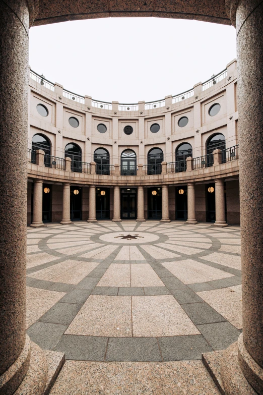 a room with multiple columns and a round staircase