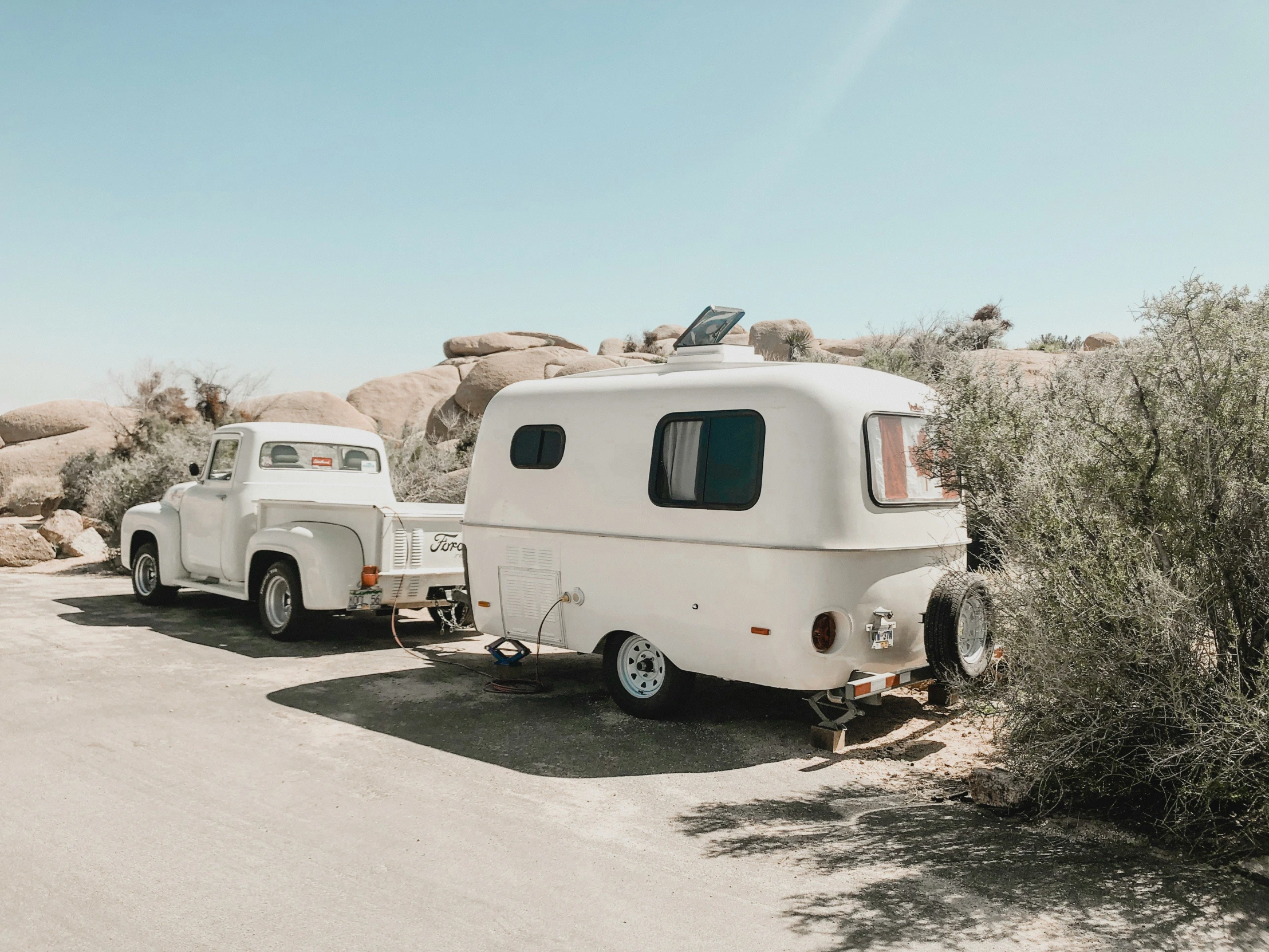 a couple of vehicles parked in the middle of a desert