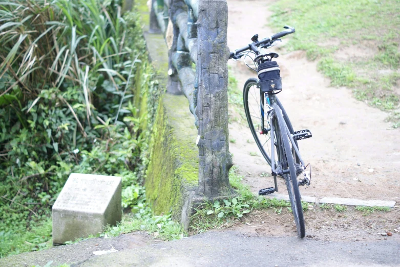 a bike parked next to a stone marker