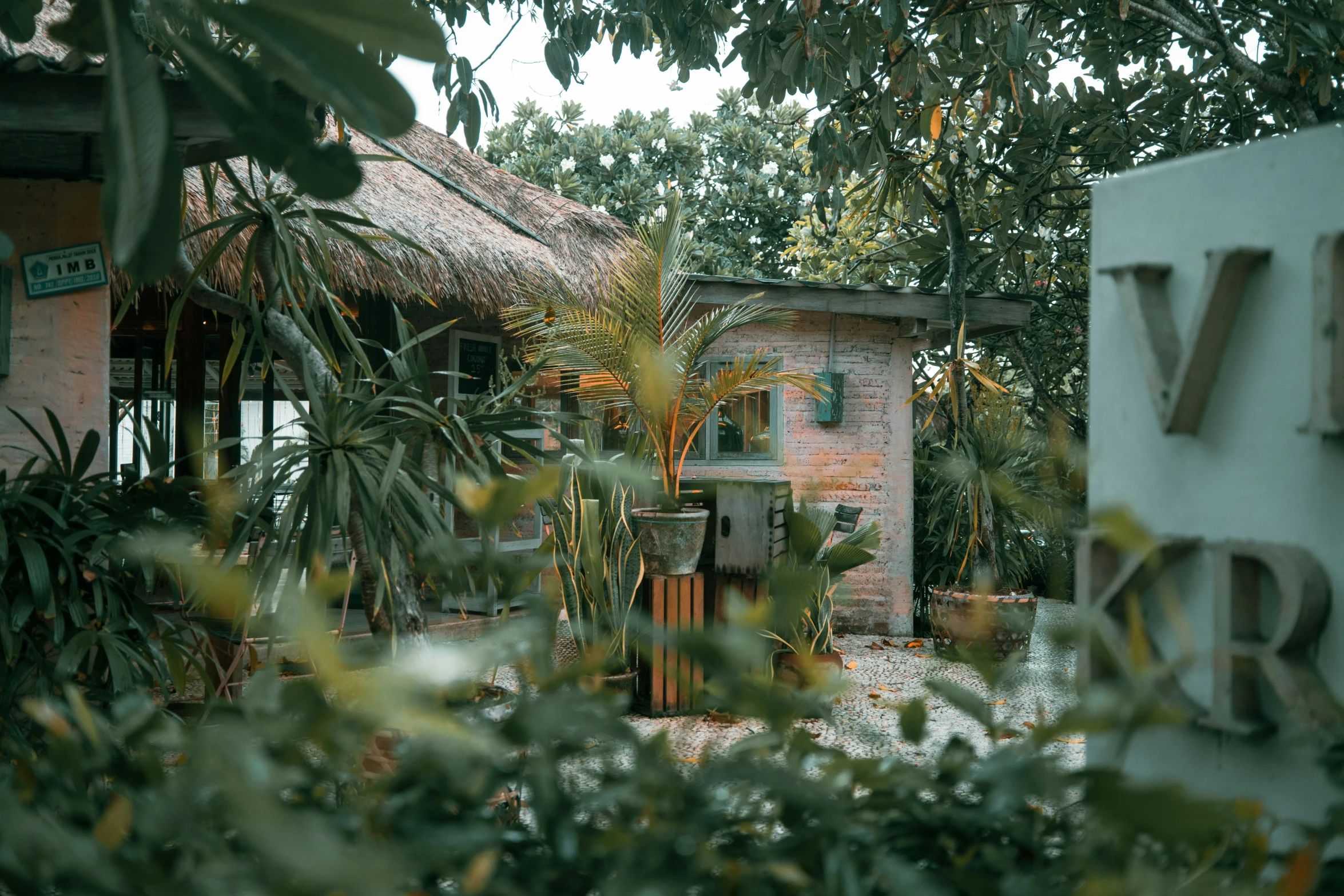 a rustic building is seen through the trees