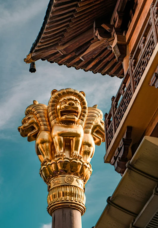 a decorative column stands beneath a blue sky