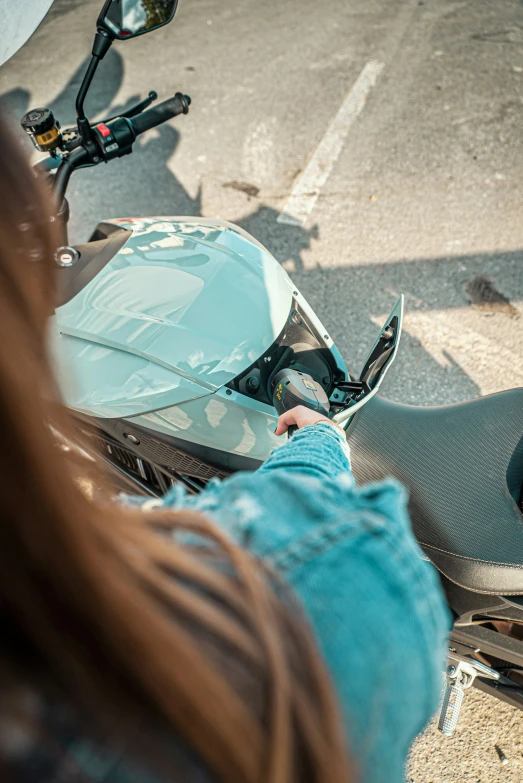 a person riding a motorcycle with a light blue outfit
