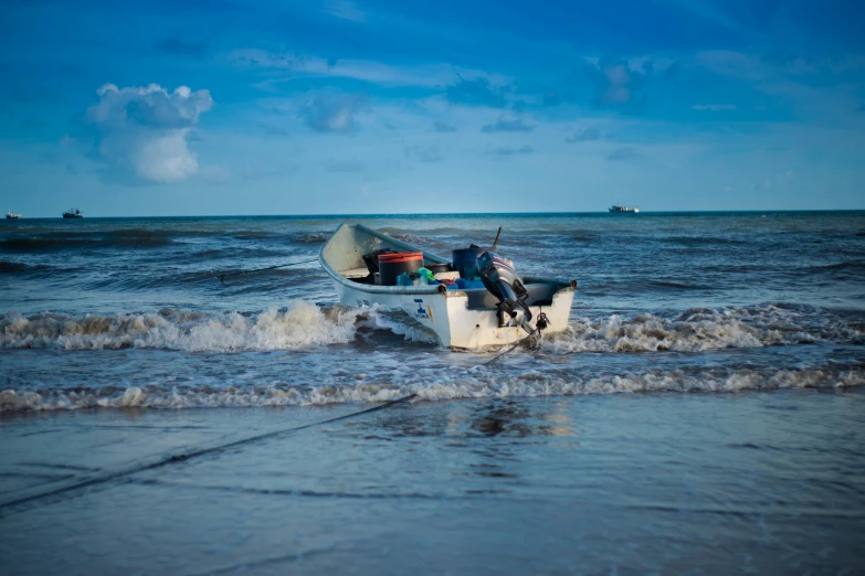 a boat sitting in the middle of water with some people inside it