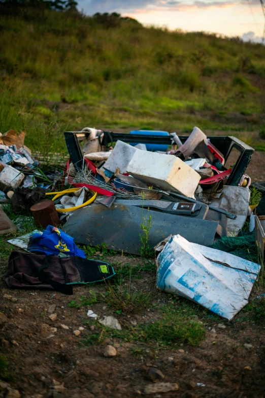 garbage left on a field and the grass is green