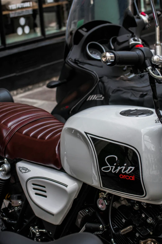 a close up of a motorcycle with red leather seat