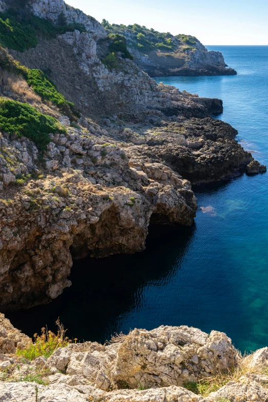 water is clear and a mountain and blue sky