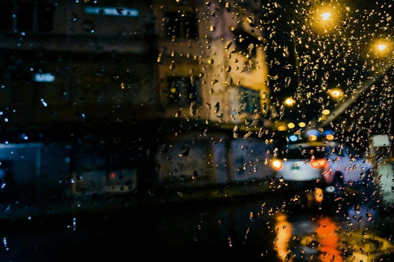 a city street with some rain all over the window