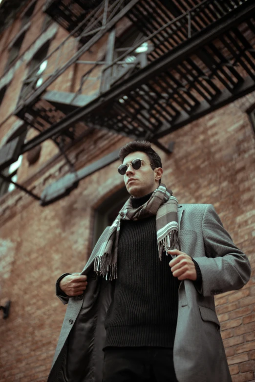 the man is walking in front of a brick building