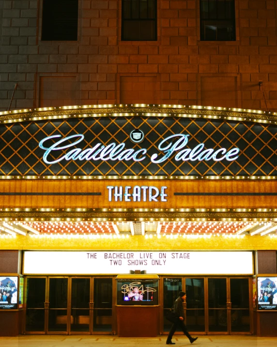theater sign above neon lit building saying'pacific palace theatre '