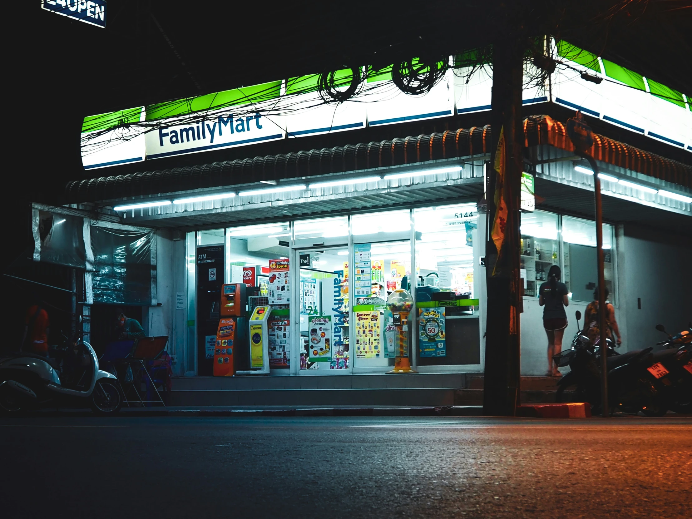 a motorcyclist waits at a motorcycle shop