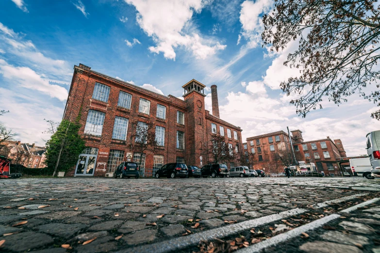 a brick building is set amongst an old brick road