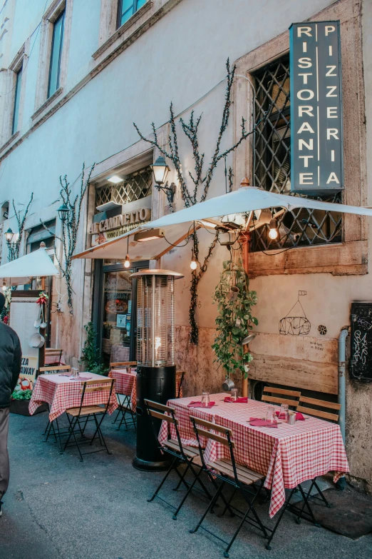 a restaurant with tables, chairs and an umbrella