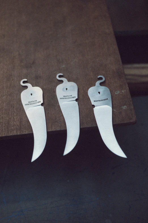 three knives with a single blade are placed on the table