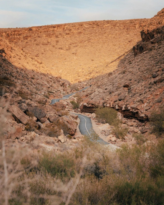 a winding road near a huge mountainous area