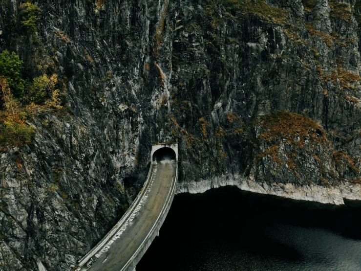 a scenic landscape showing a mountain lake with road winding into the side