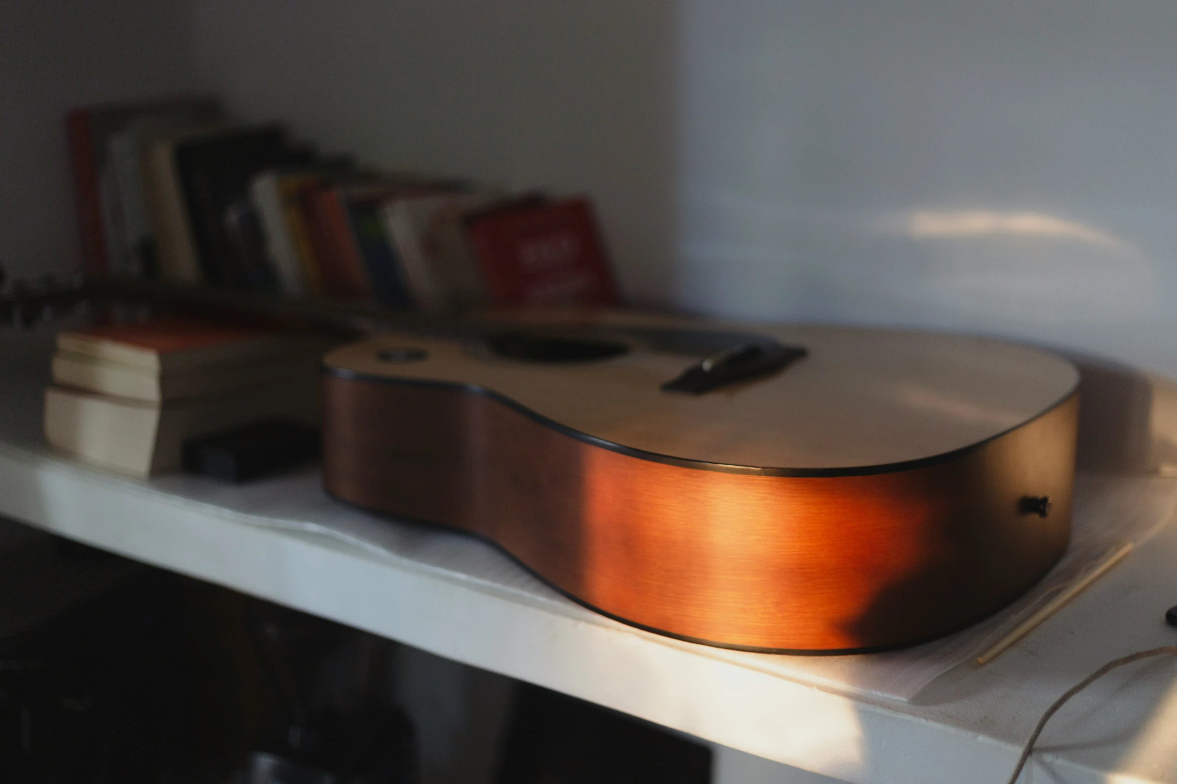 a guitar is propped against a white mantle in a home