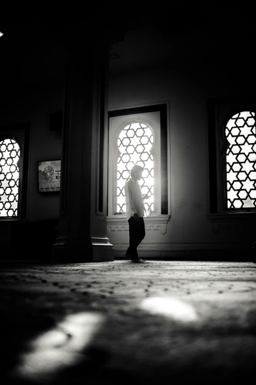 a woman standing on the ground looking at a window